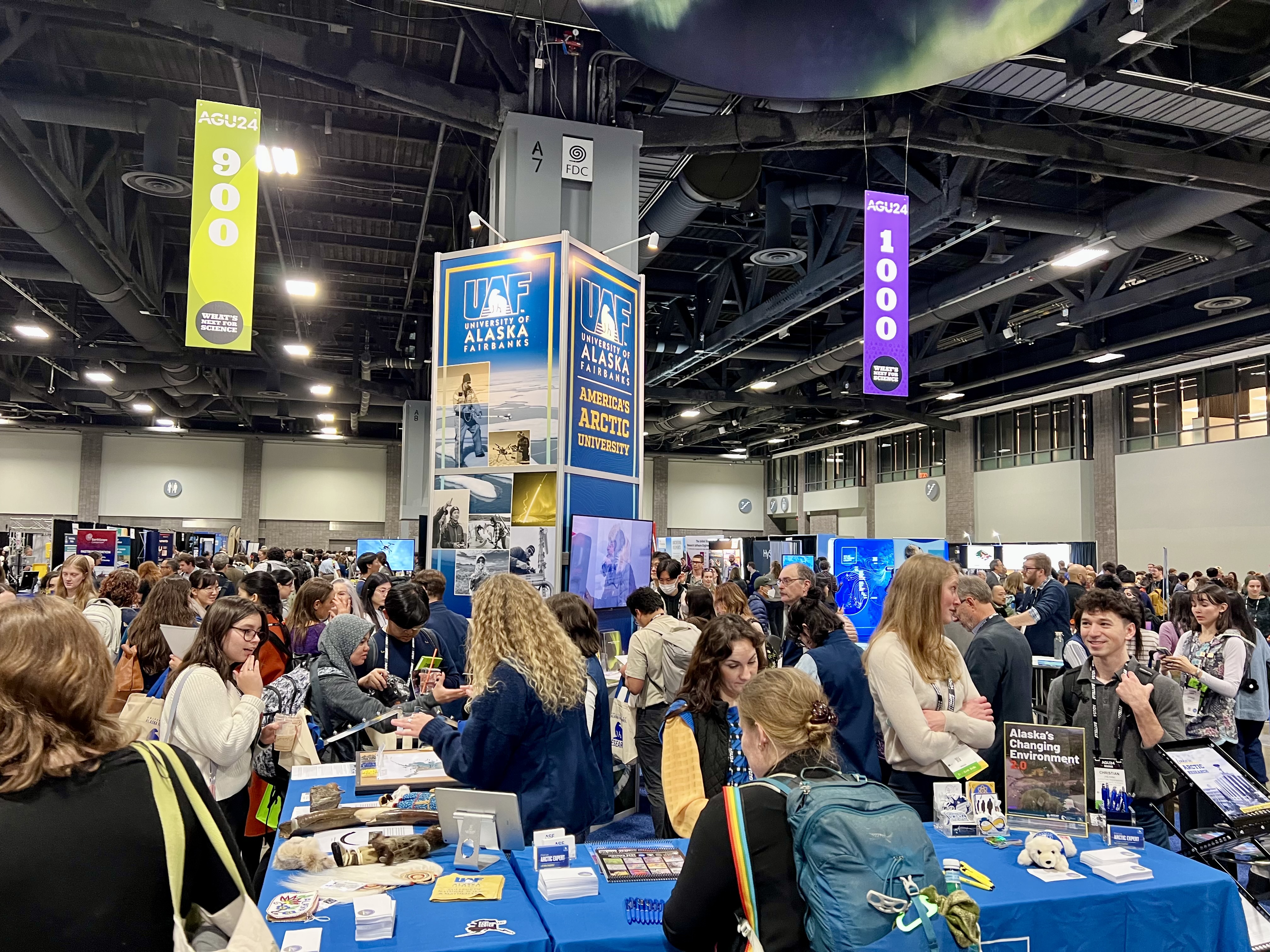 The UAF booth is filled with visitors during the initial opening rush as attendees explored the AGU24 Exhibit Hall on the afternoon of Dec. 9.