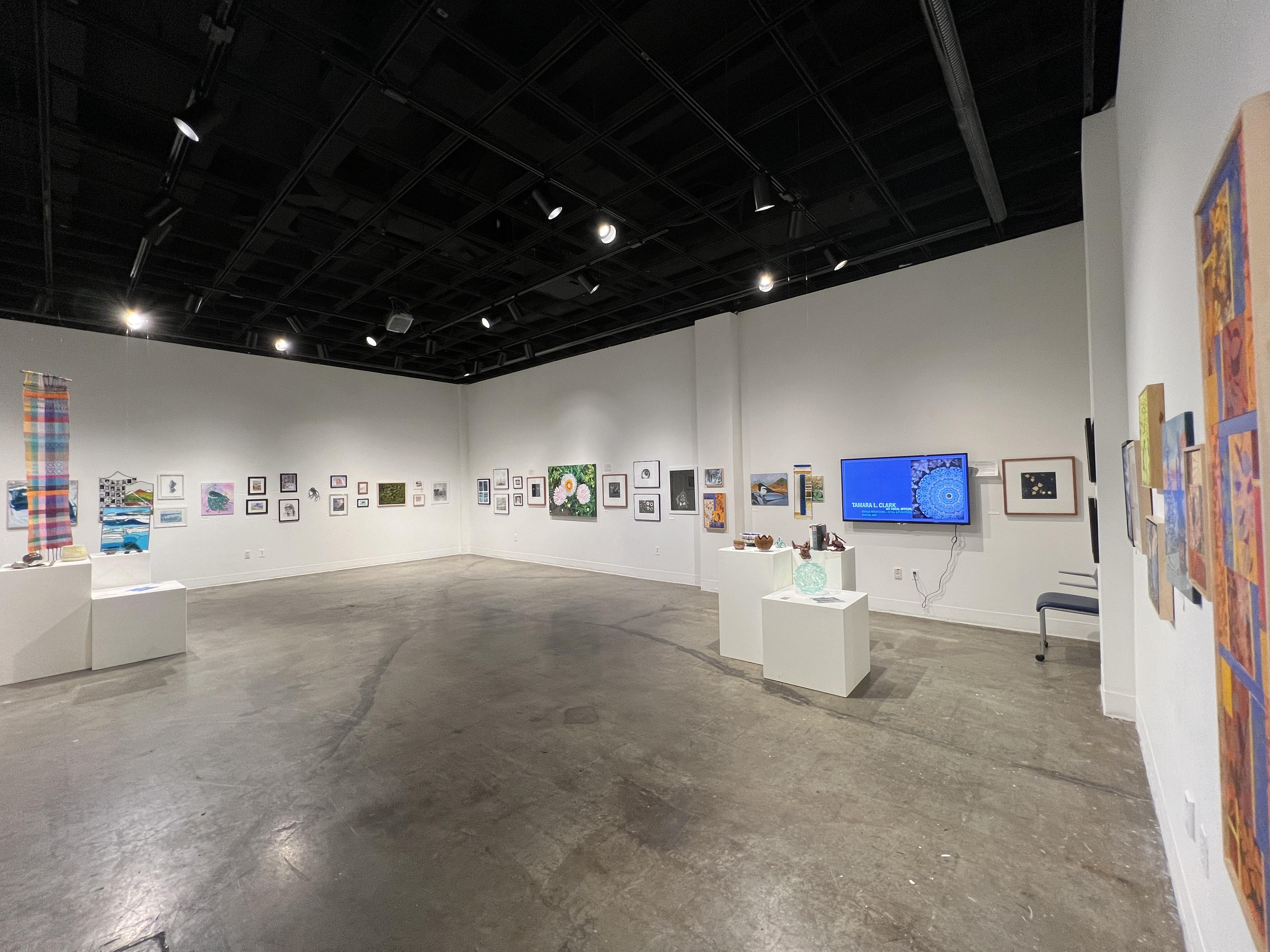 One view of the gallery installation of nearly 90 art pieces in the Beyond the 9-5 exhibit in the University Art Gallery of the Fine Arts Complex.