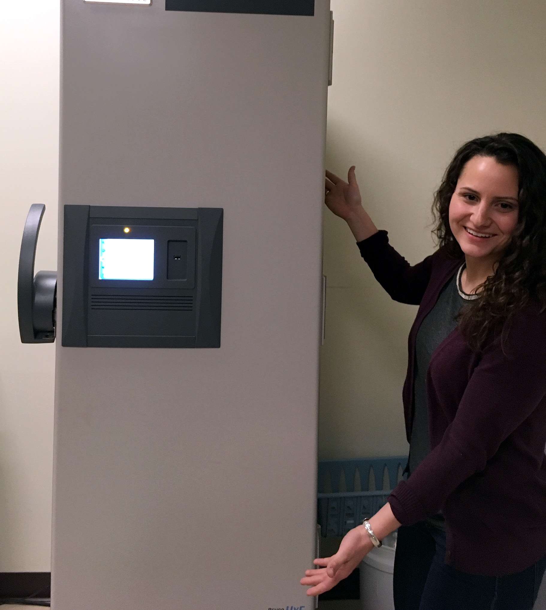 BLaST graduate assistant Madison Kosma shows off a new BLaST-funded freezer to be used in the Straley lab at the University of Alaska Southeast Sitka campus.