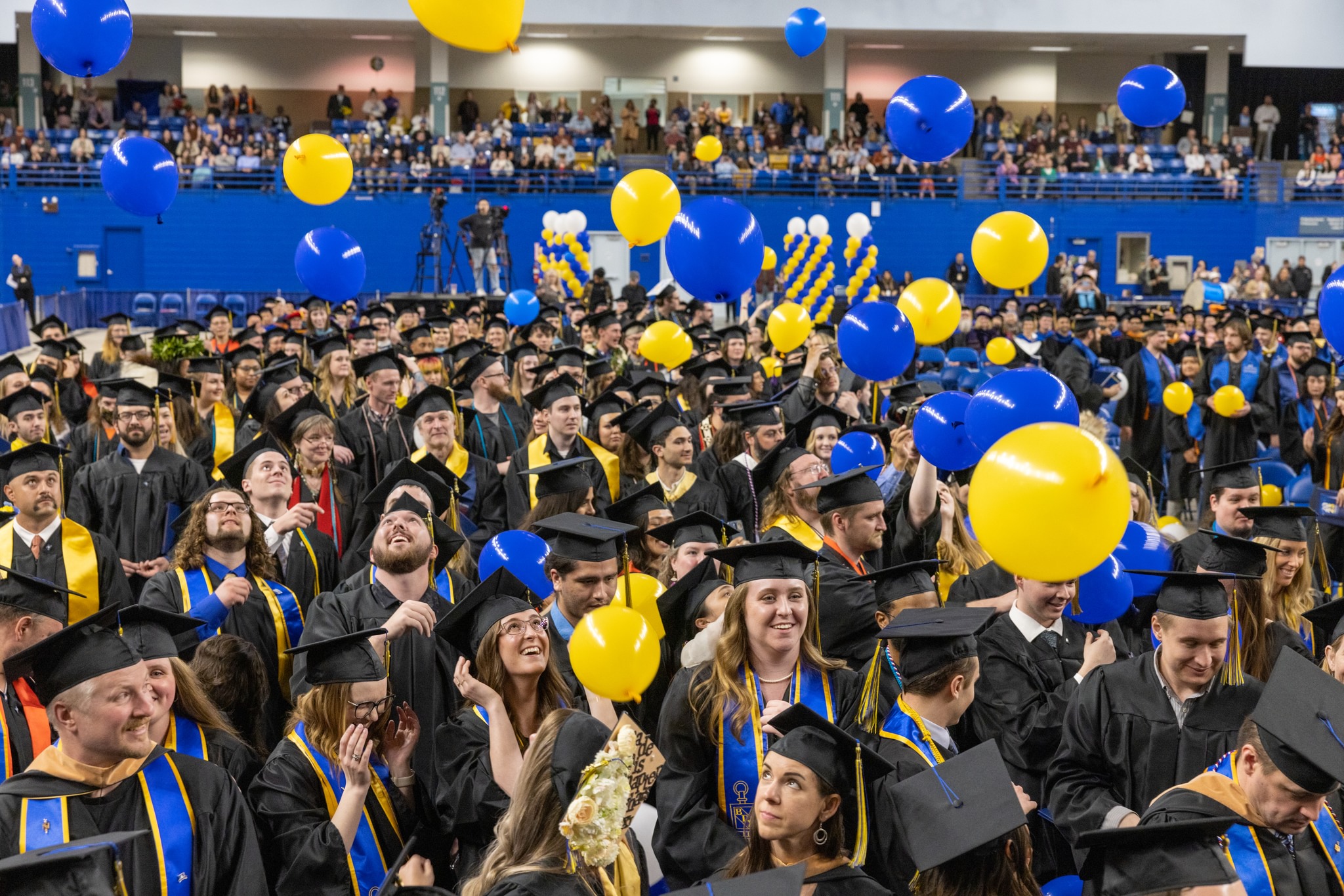 Graduates celebrate during the balloon drop during UAF's 2023 Commencement Ceremony at the Carlson Center in Fairbanks.