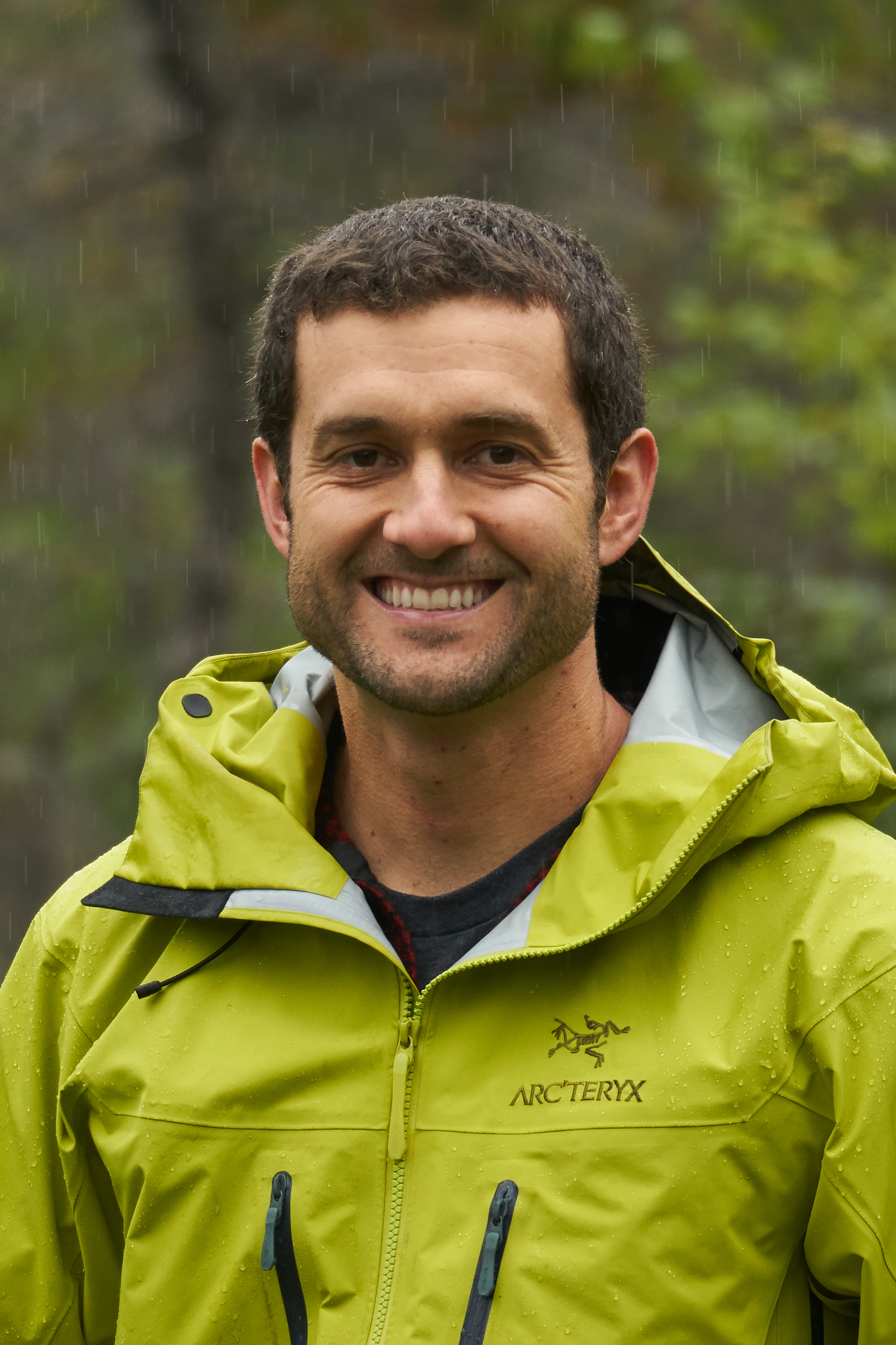 John Harley stands out in woods during a rainy day in Juneau, Alaska.