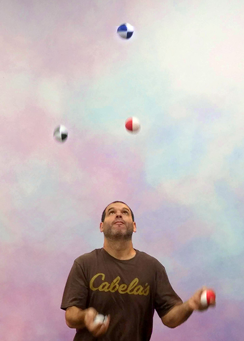 Juggling instructor, Nadav Weiss, demonstrates how to juggle multiple items at once.