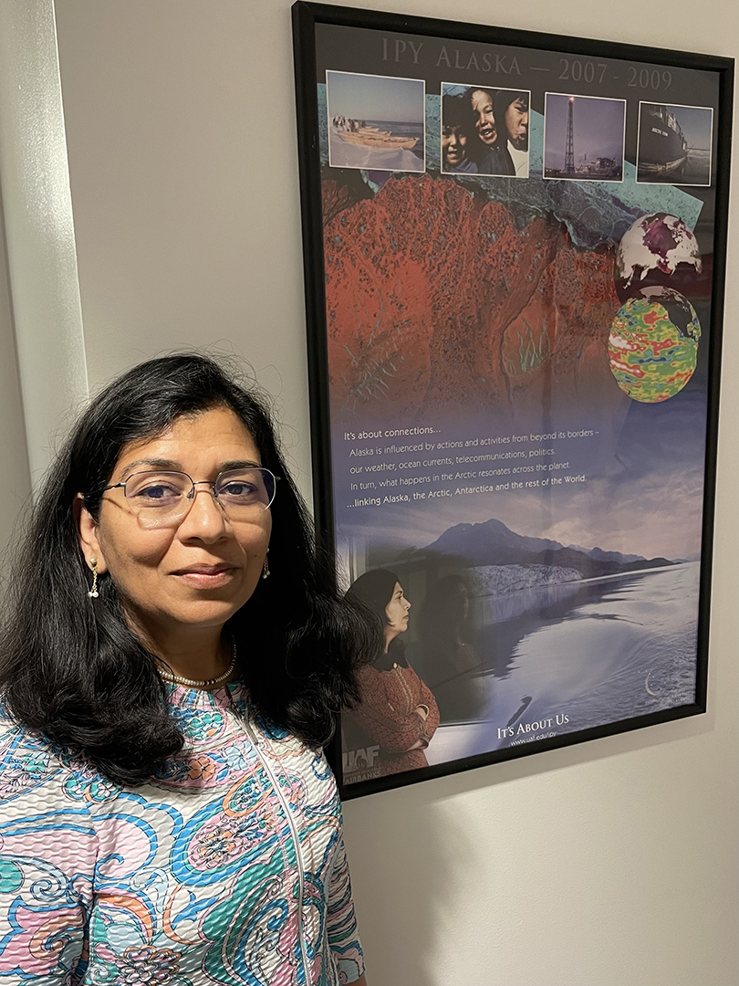 Provost Anupma Prakash takes a moment to pause next to a poster from the 4th International Polar Year that commenced in 2007 when she was a faculty member at UAF.