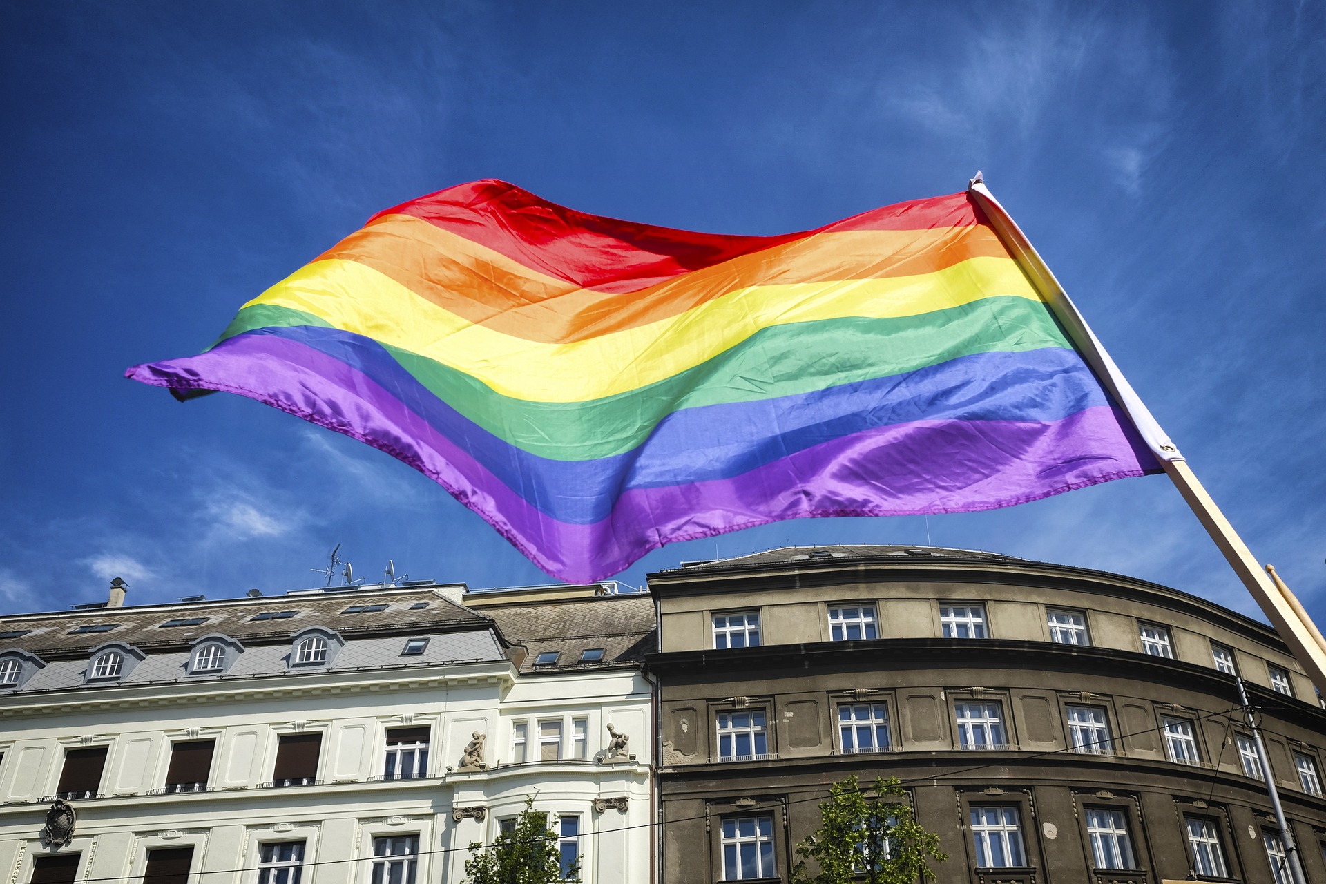 Rainbow flag for LGBTQIA2+ is pictured over a building
