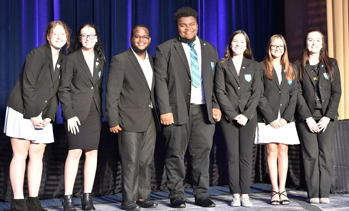 Torrey McClain is on the far right, standing with three fellow officers, and three officers from last year's lineup of national student officers. (Credit: Educators Rising Alaska staff)