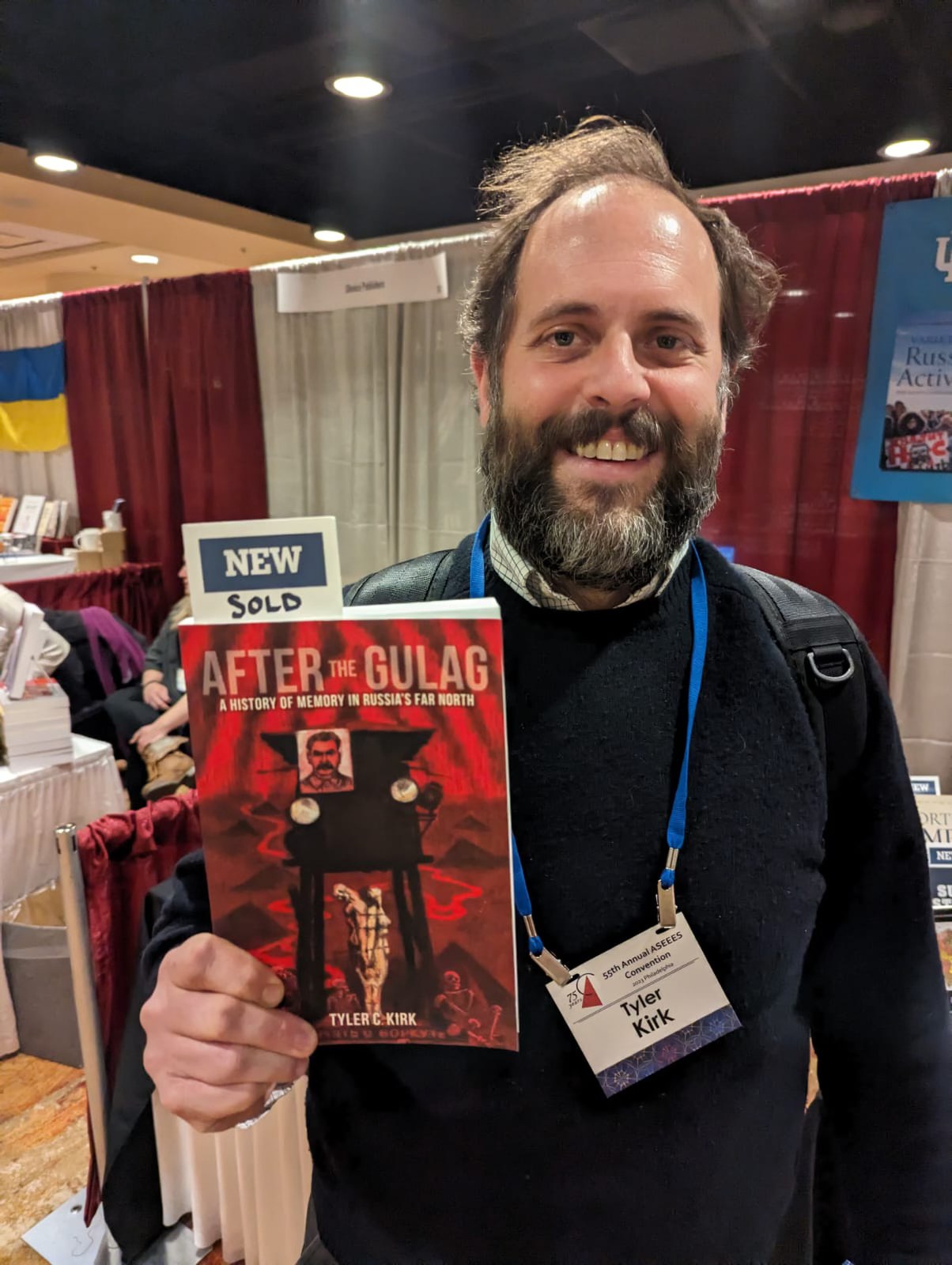 Tyler Kirk holding his newly published book, “After the Gulag: A History of Memory in Russia’s Far North.”