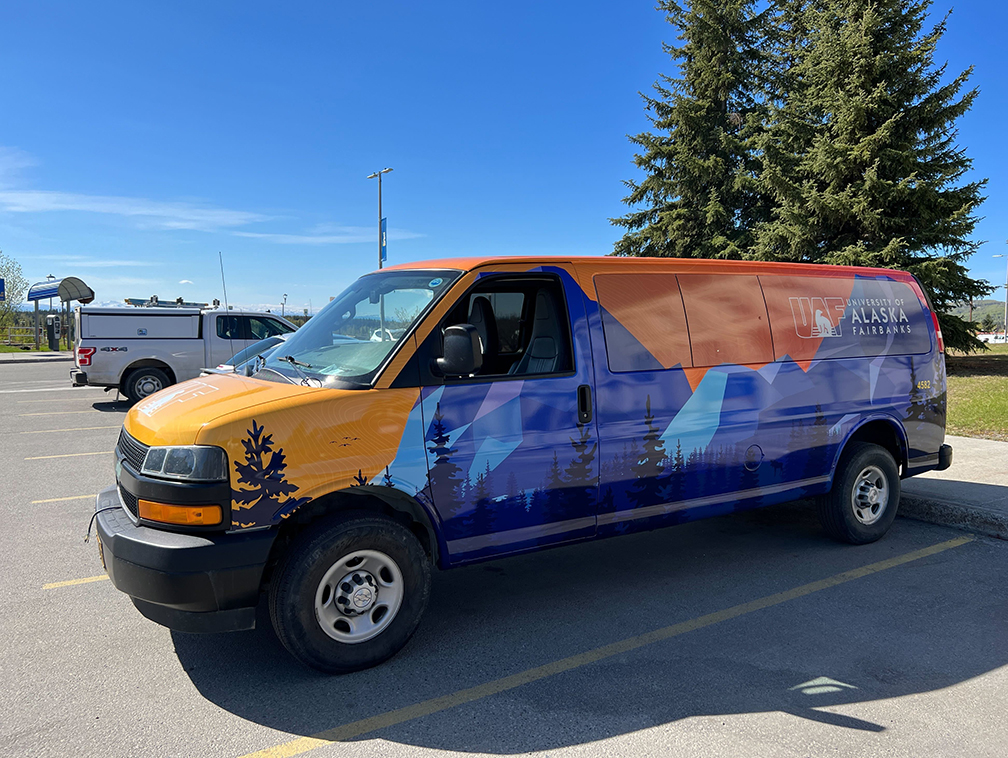 A UAF shuttle sports a new wrap recently installed onto the vehicle.