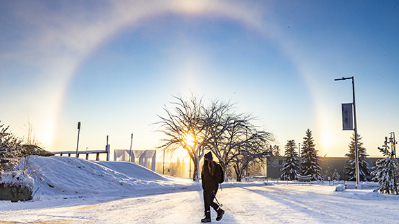 A sundog is seen from the Troth Yeddha' campus as a student walks to class Nov. 2, 2020.
