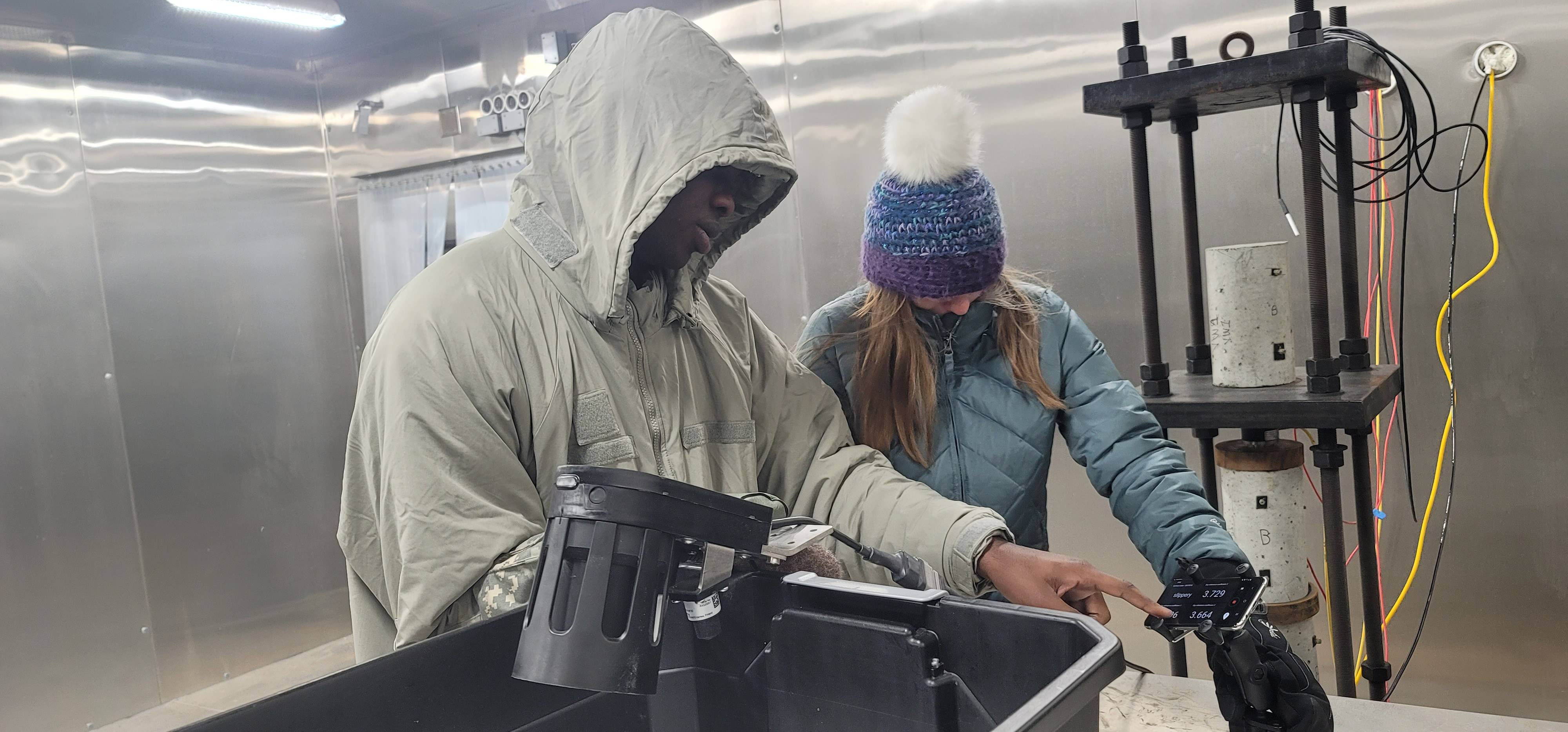 Lindy Guernsey and fellow X-Force team member work in -40 degree F conditions inside the cold chamber.  Photo by Artsiom Studzianok.