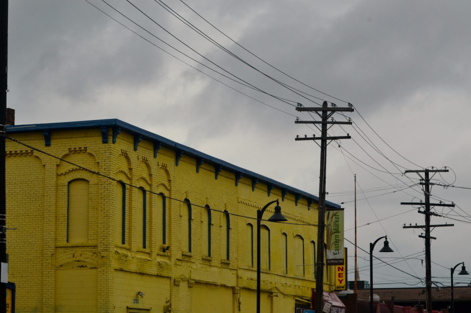 Photo of a yellow brick building on an overcast day by Michelle Brooks