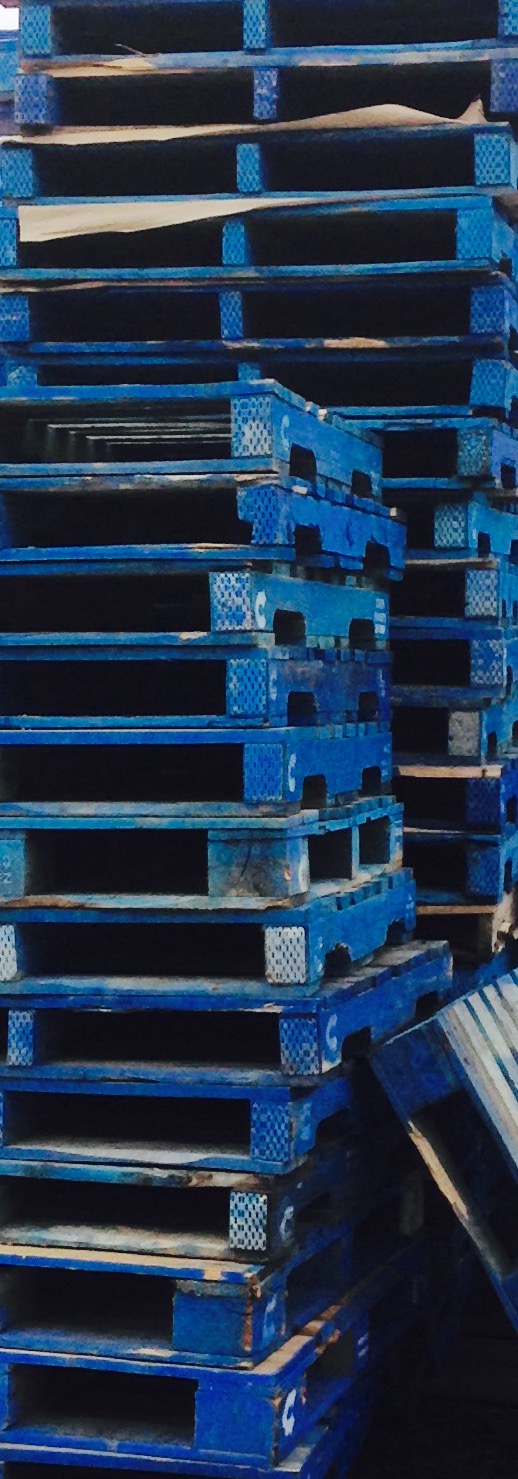 Tall stack of blue wooden pallets by Brian Michael Barbeito