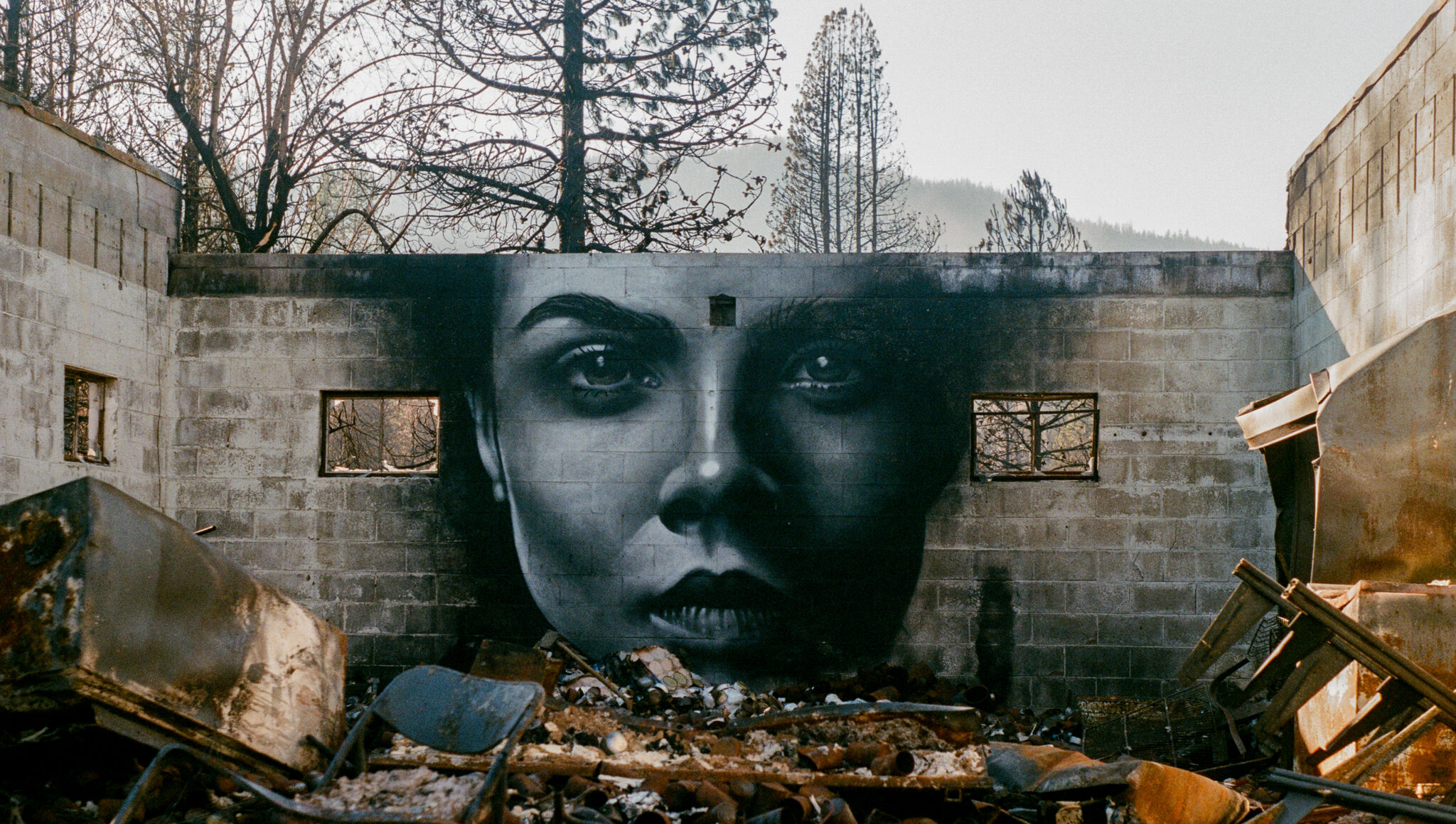 photo of a mural in the remains of an abandoned building | Photo by Sage Cruser