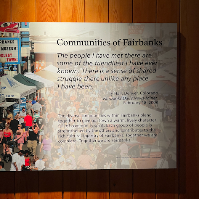 A plaque with a quote about Fairbanks by Ty Hall - The people I have there are some of the friendliest I have ever known. There is a sense of shared struggle there unlike any place I have been. 