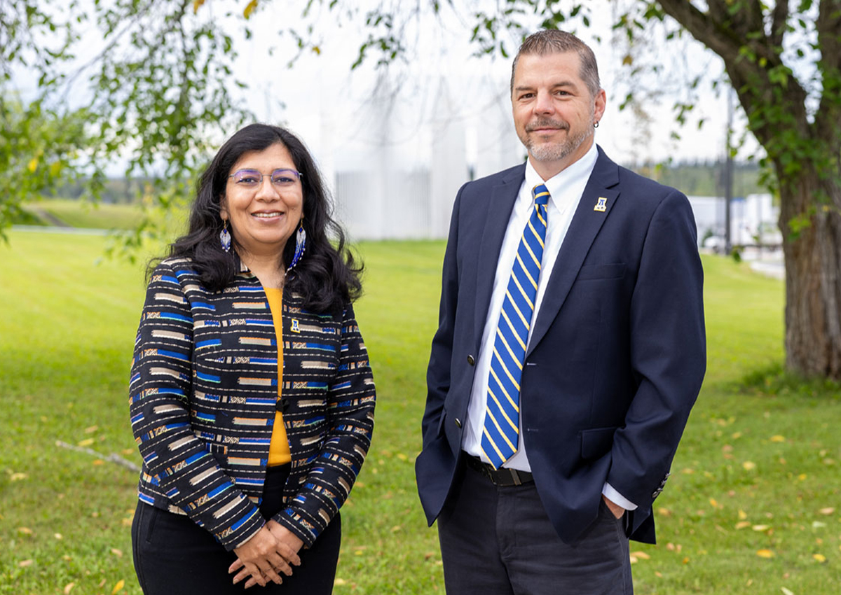 Provost Anupma Prakash and Vice Provost Trent Sutton standing outdoors.  