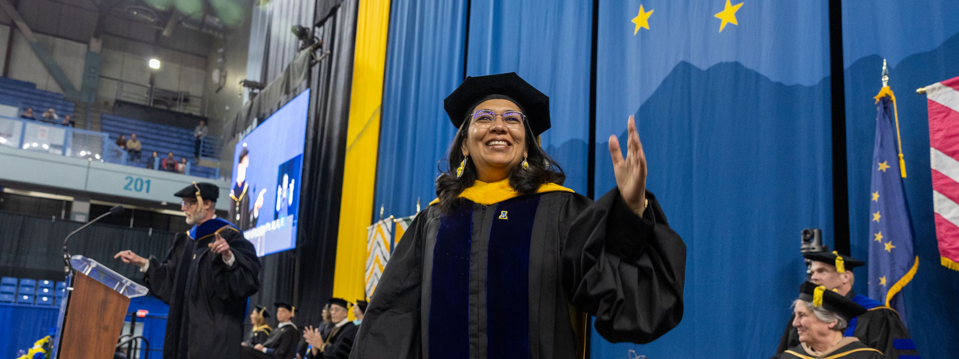 Anupma Prakash waves to the audience at the UAF 20204 Commencement Ceremony at the Carlson Center