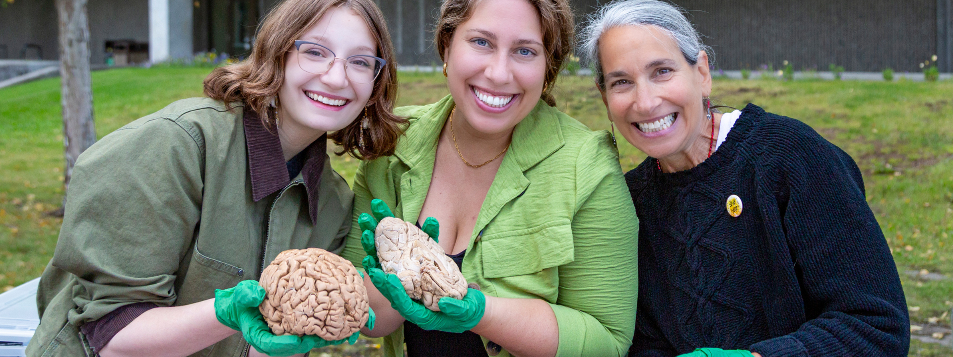 A student poses with a brain specimen alongside psychology faculty Christine Kindler and Ellen D.S. Lopez at UAF's 2025 Party in the Park. UAF Photo by Sarah Manriquez
