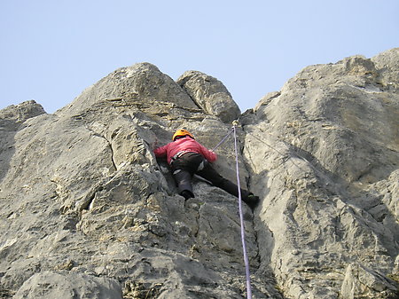 Climber nearing the top of the crag