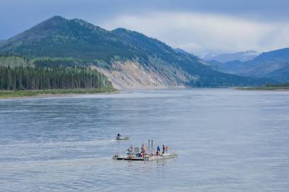 A crew from Alaska Power and Telephone work to position a barge and anchors in the Yukon River near Eagle, Alaska. The utility is working with researchers from the UAF's Center for Energy and Power on deployment of a hydrokenetic generator to provide energy to local residents.