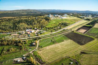 An aerial view of UAF looking east toward Fairbanks with the experiment farm in the foreground