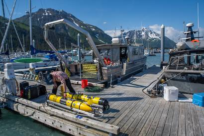 Hank Statscewich, research staff at CFOS, goes out on the RV Nanuq to retrieve one of his research gliders after a record-setting 110-day voyage.