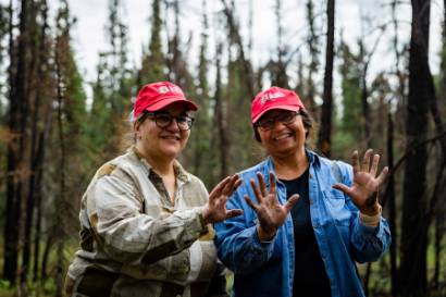 Chirs Waigl (left) and Uma Bhatt (right) show their charcoal covered hands after conducting fieldwork at the Yankovich Burn Site