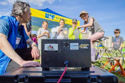 Alaska Center for Energy and Power teaches children about electricity with the bike generator during the 2024 UAF Arctic Research Open House