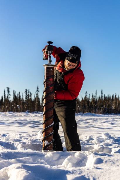 IARC faculty Marc Oggier works with students from the Climate Scholars Program during a trip to Ballaine Lake, where they were taught how to collect lake ice core samples as part of an Arctic Ice Research course