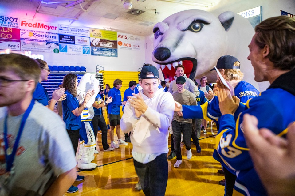 A photo of tha UAF orientation happening in the gym with excited students and Nook, the polar bear mascot of UAF
