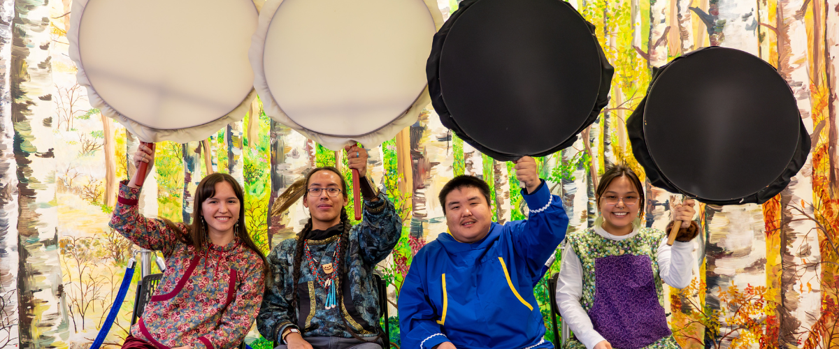 Four students hold drums for Indigenous Peoples Day