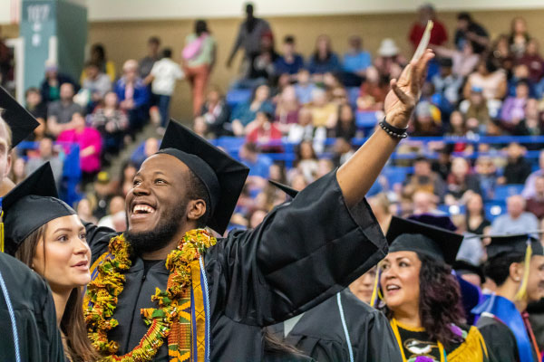 Graduating student Claine Plummer Jr. celebrates with the crowd during the UAF 2024 Commencement Ceremony