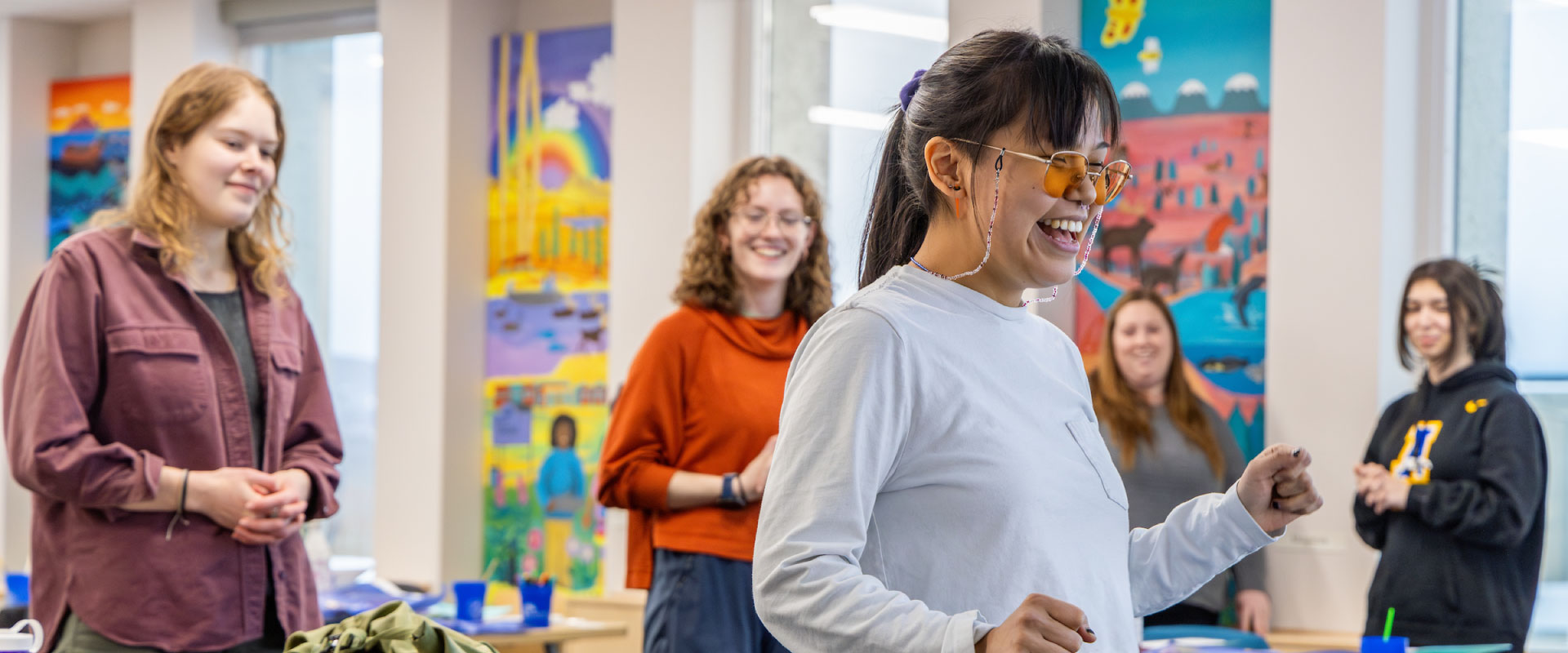 A school of education student teacher teachers her classmates Indigenous dances during a class