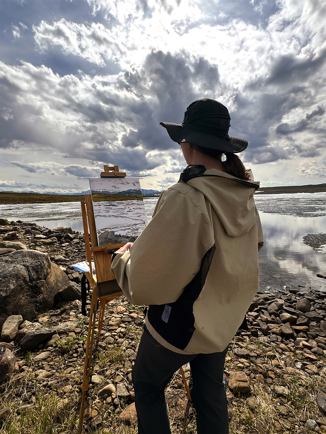 A individual in front of their painting