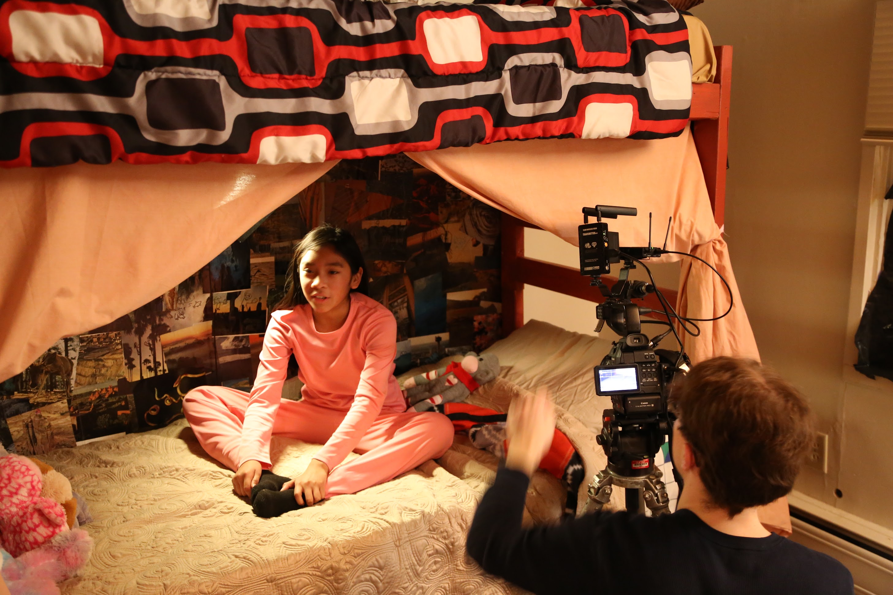 Melora James (CHRISTINA) sits on her bed during filming for a scene from Power of Words. Photo by UAF Theatre and Film