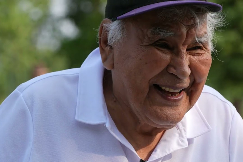 Still of a laughing Chief Andrew Jimmie from Mending the Net: Alaska Native Elders Mentoring Elders