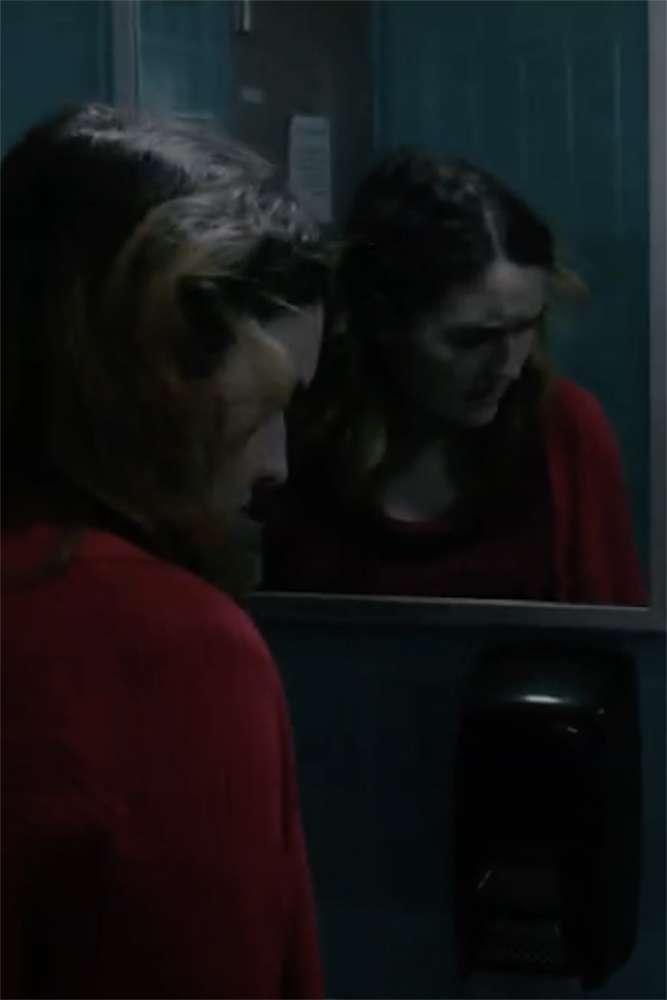 Dana (Isabelle Nygren) tries to get her bearings in a dimly lit bathroom. UAF still from Pink Violet.