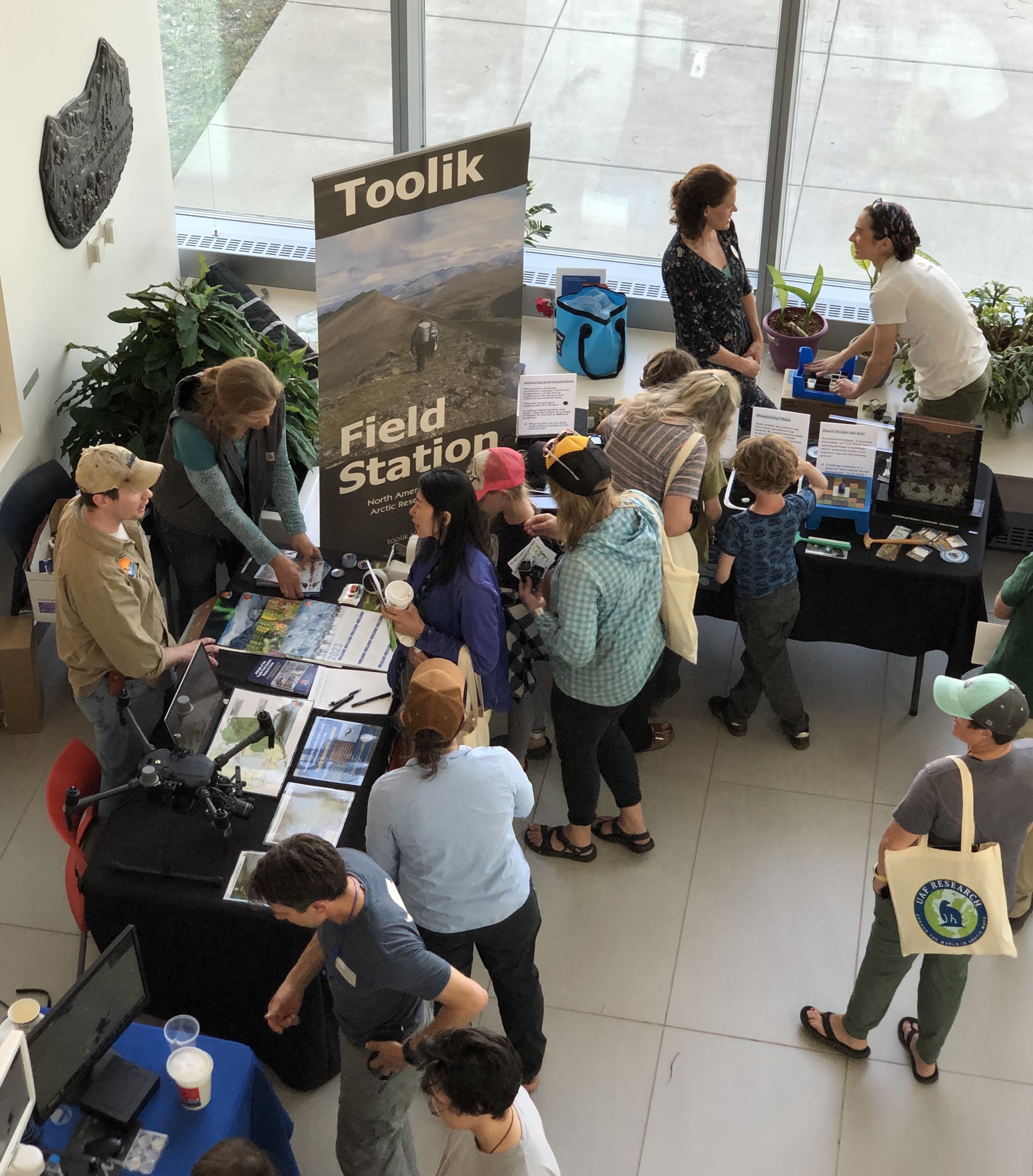 overhead shot of people visiting Arctic Research Open House tables