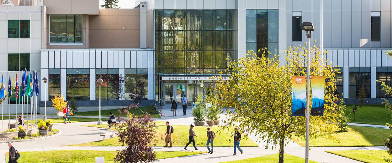Students walk through Cornerstone Plaza in front of the  Joseph E. Usibelli Engineering Learning and Innovation Building on the Fairbanks campus in autumn.