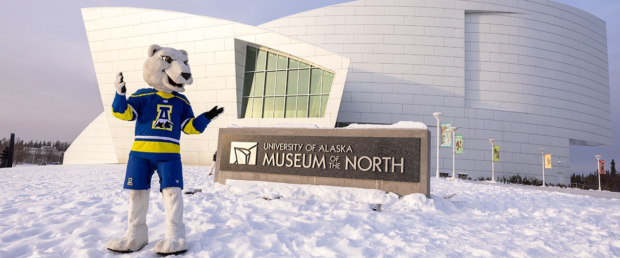 Nanook mascot poses in front of the UA Museum of the North