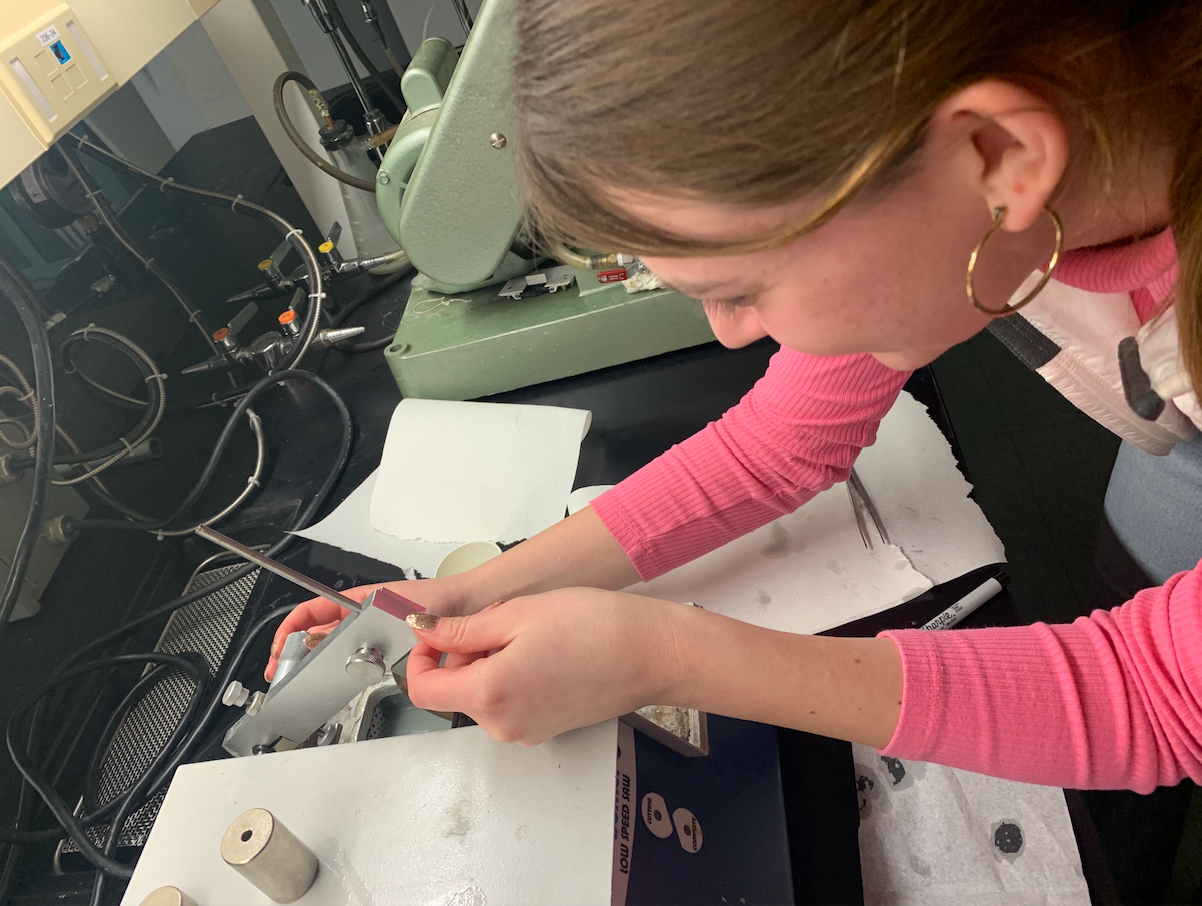 Amelia Knavel lining up an otolith to be thin-sectioned for aging and Sr stable isotope analysis by using a low speed Isomet saw.
