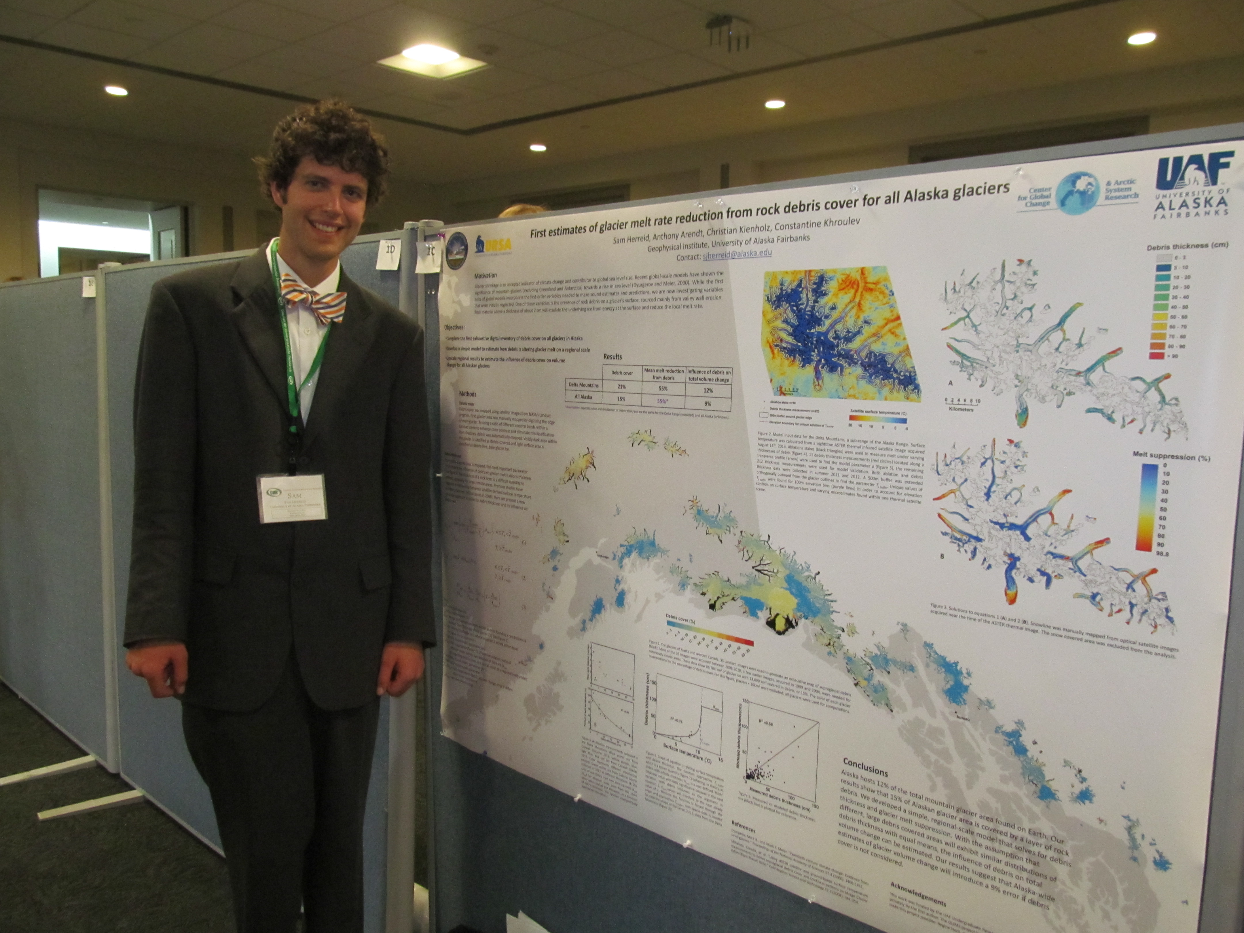 Sam Herried standing next to a research poster.