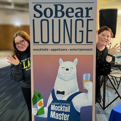 Julia Aikman and student, Amara Juneau, with the SoBear Lounge Sign