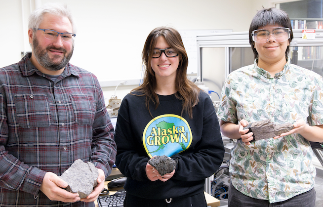 Mentor with two students holding rocks in the lab