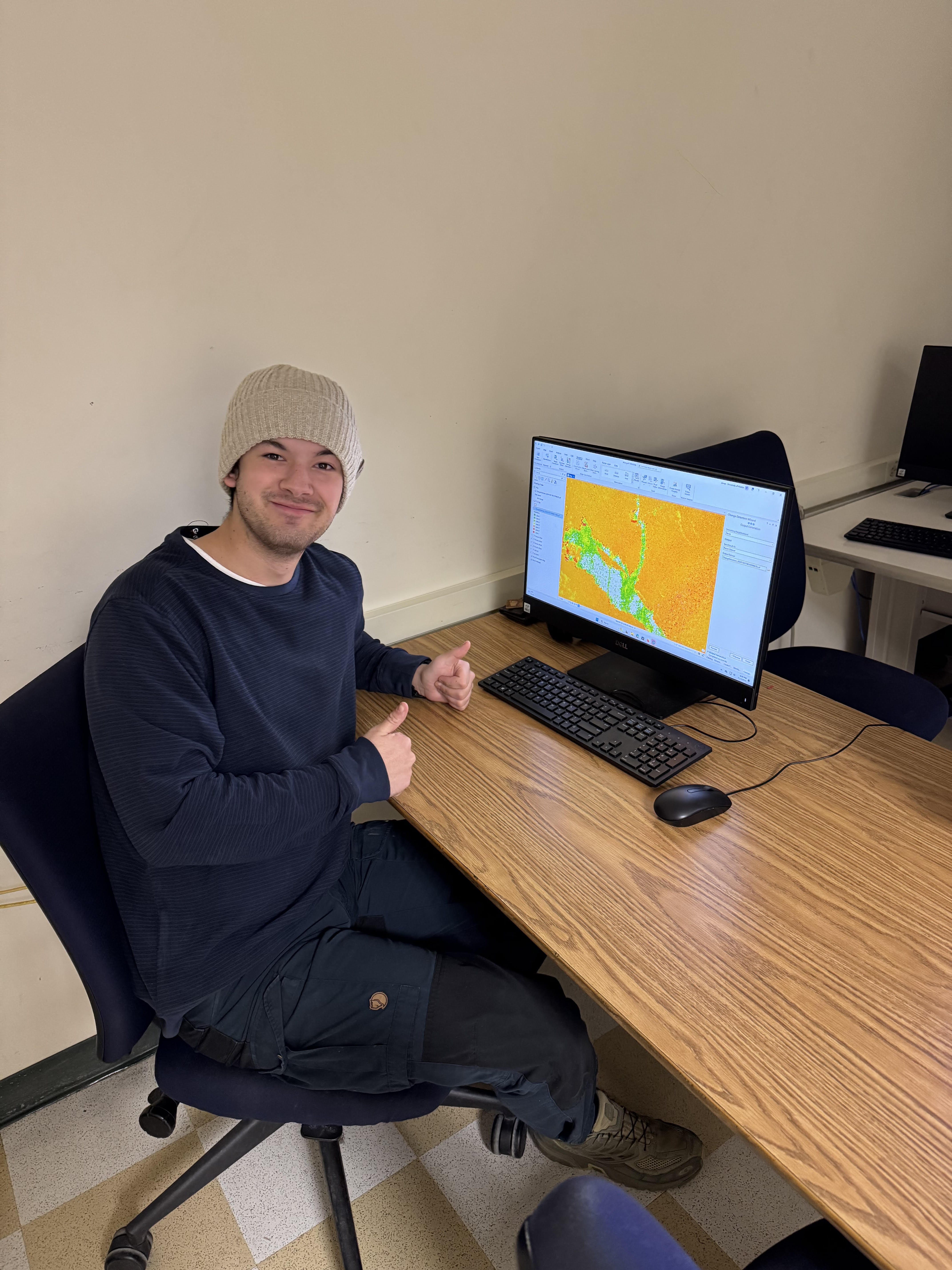 Jonas at a desk with data on the screen. 